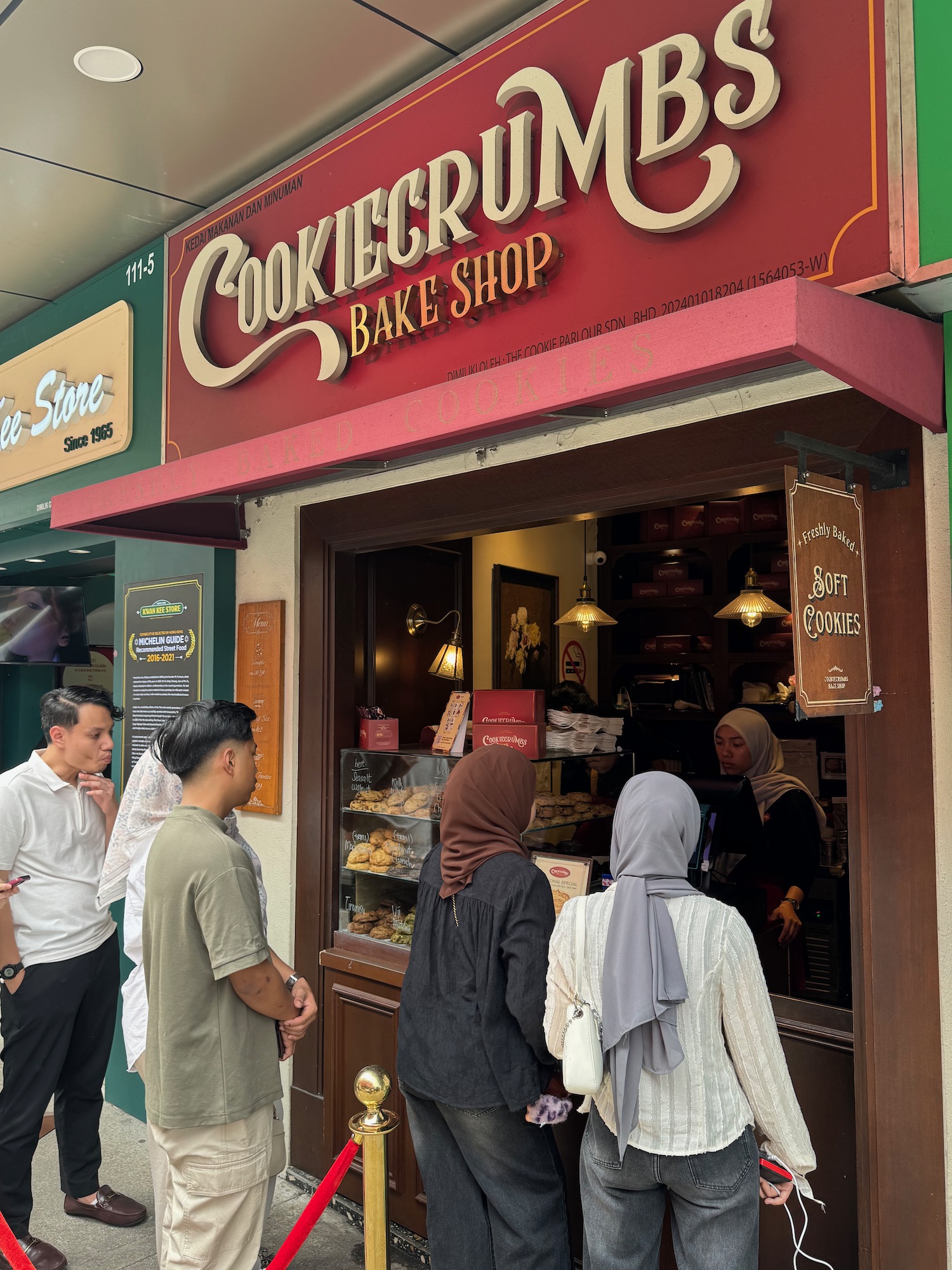 a group of people standing outside a store