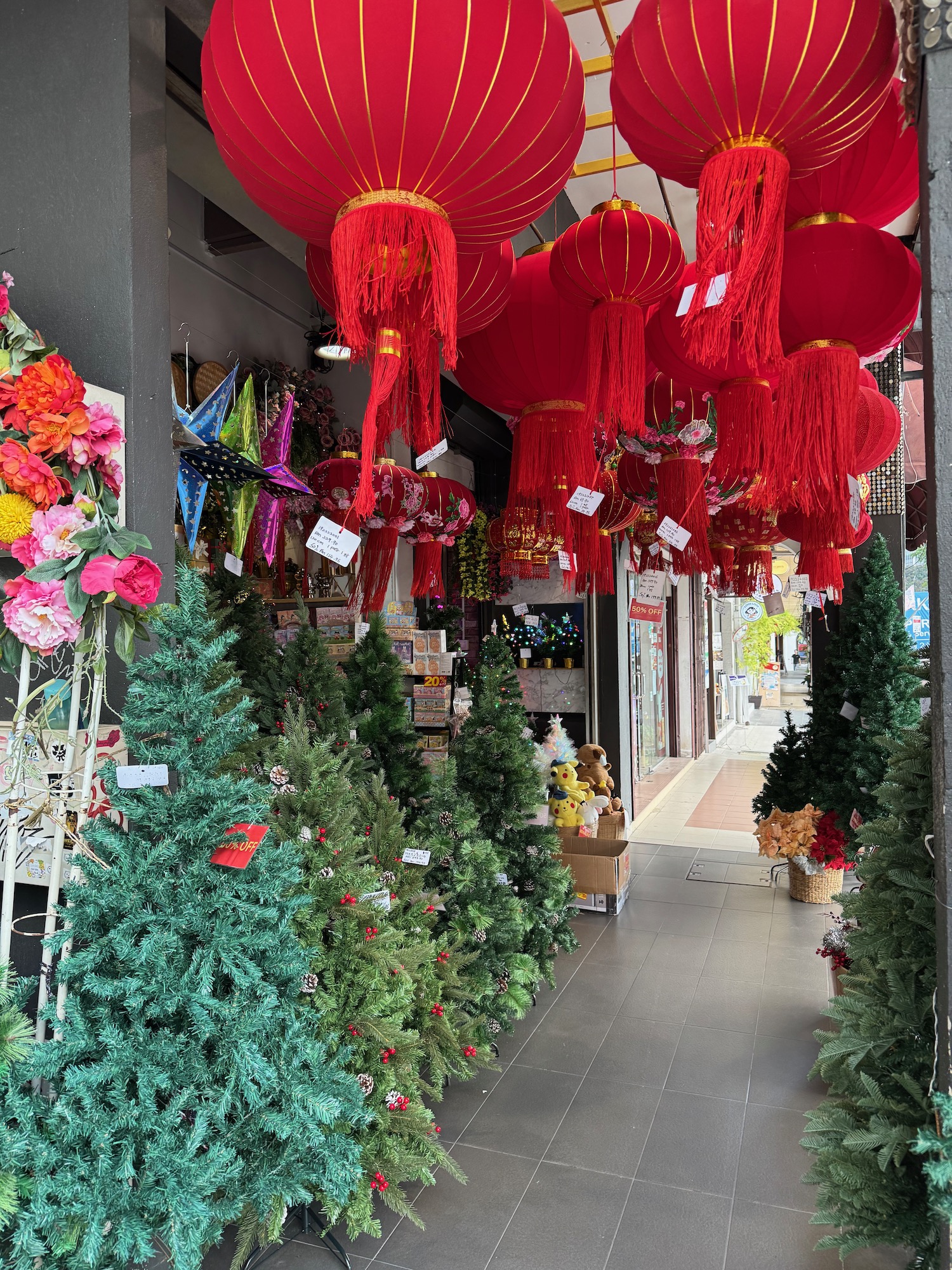 a store with red lanterns and trees