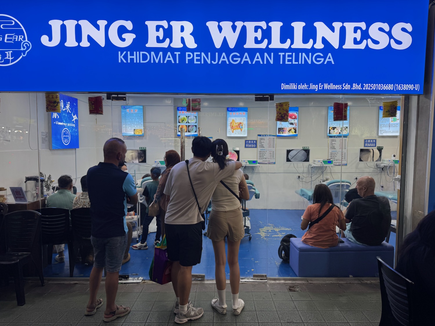 a group of people standing in front of a window
