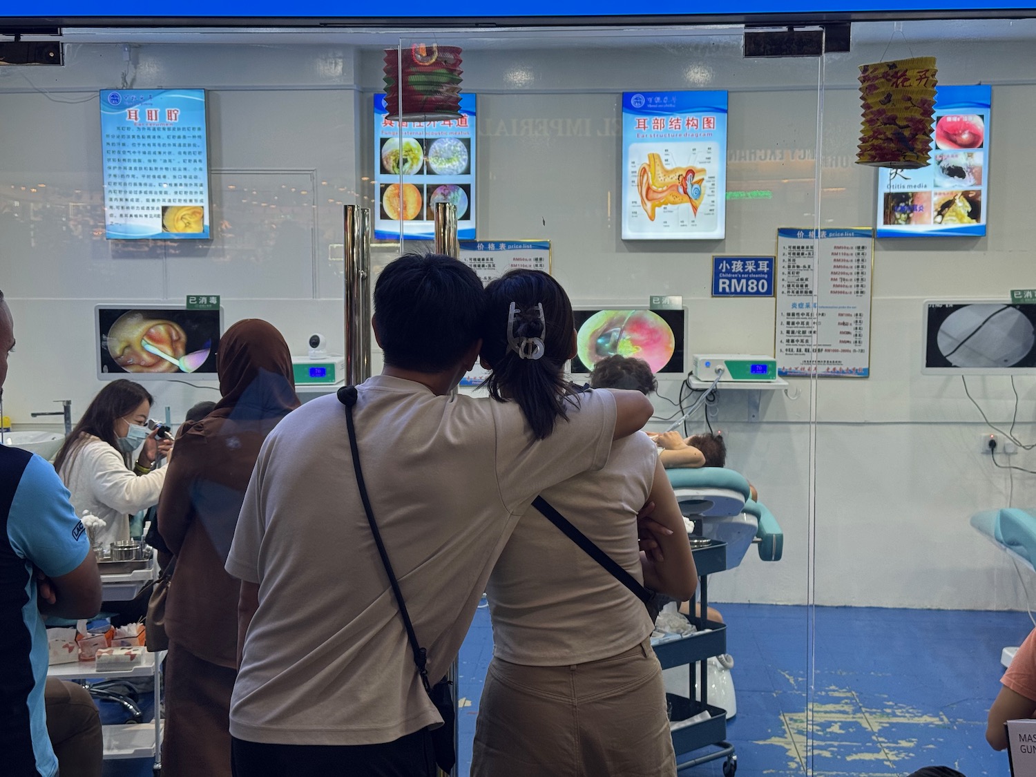 a man and woman standing in front of a window