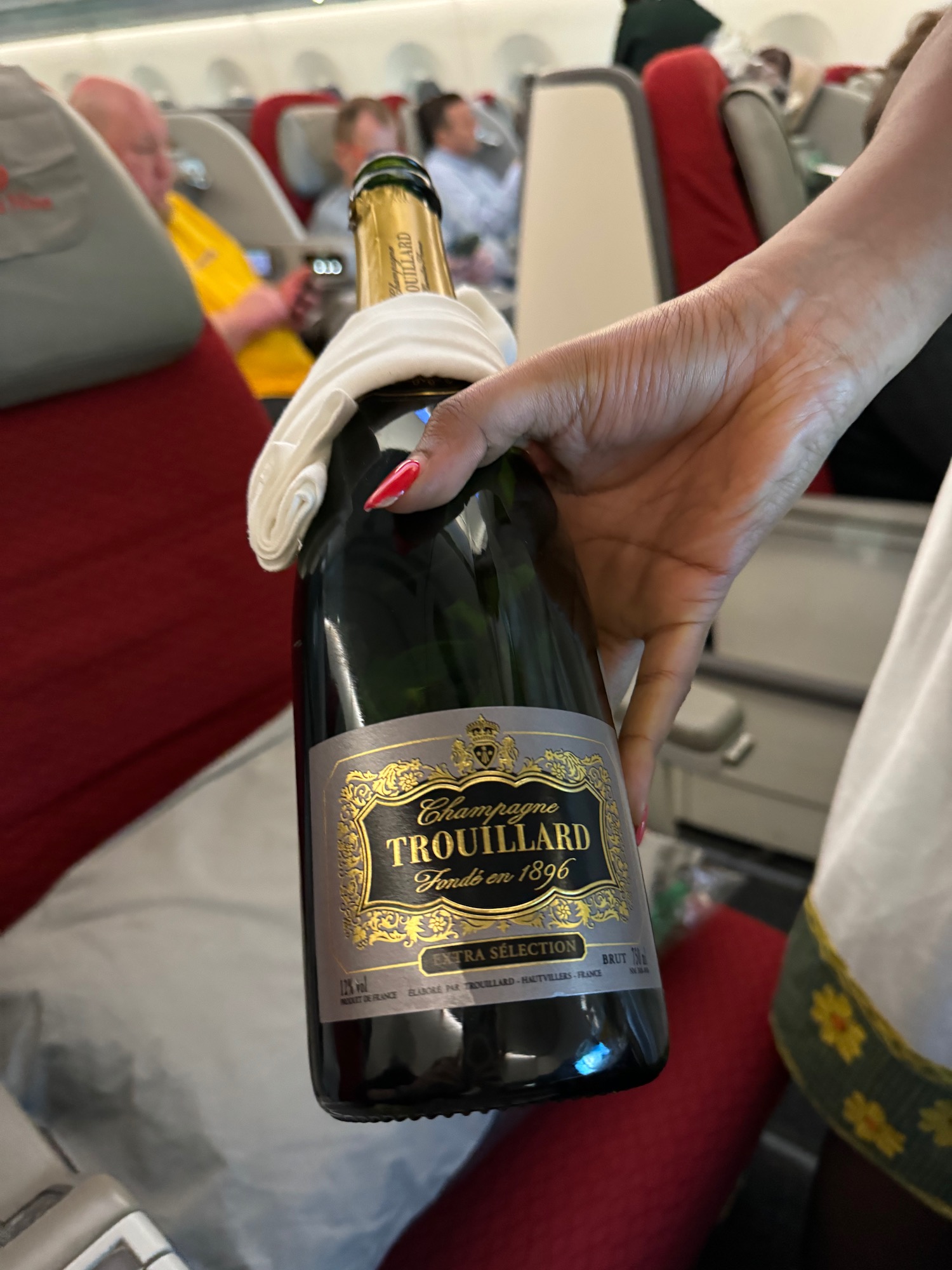 a hand holding a bottle of champagne