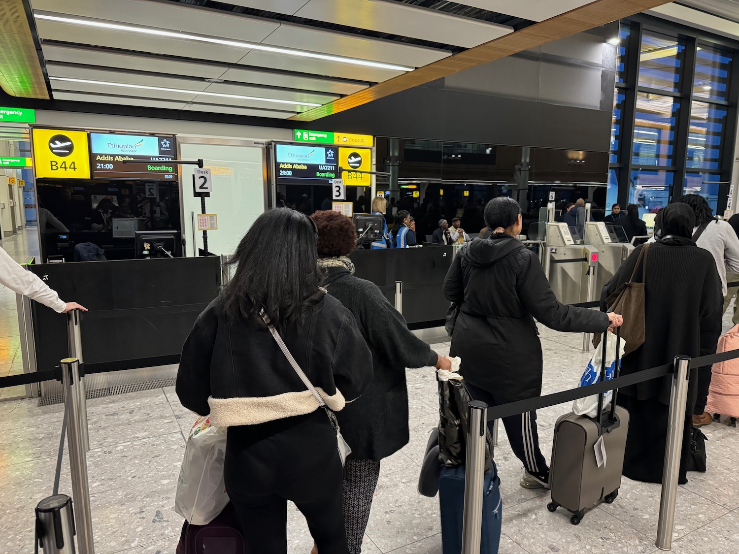 a group of people with luggage in an airport