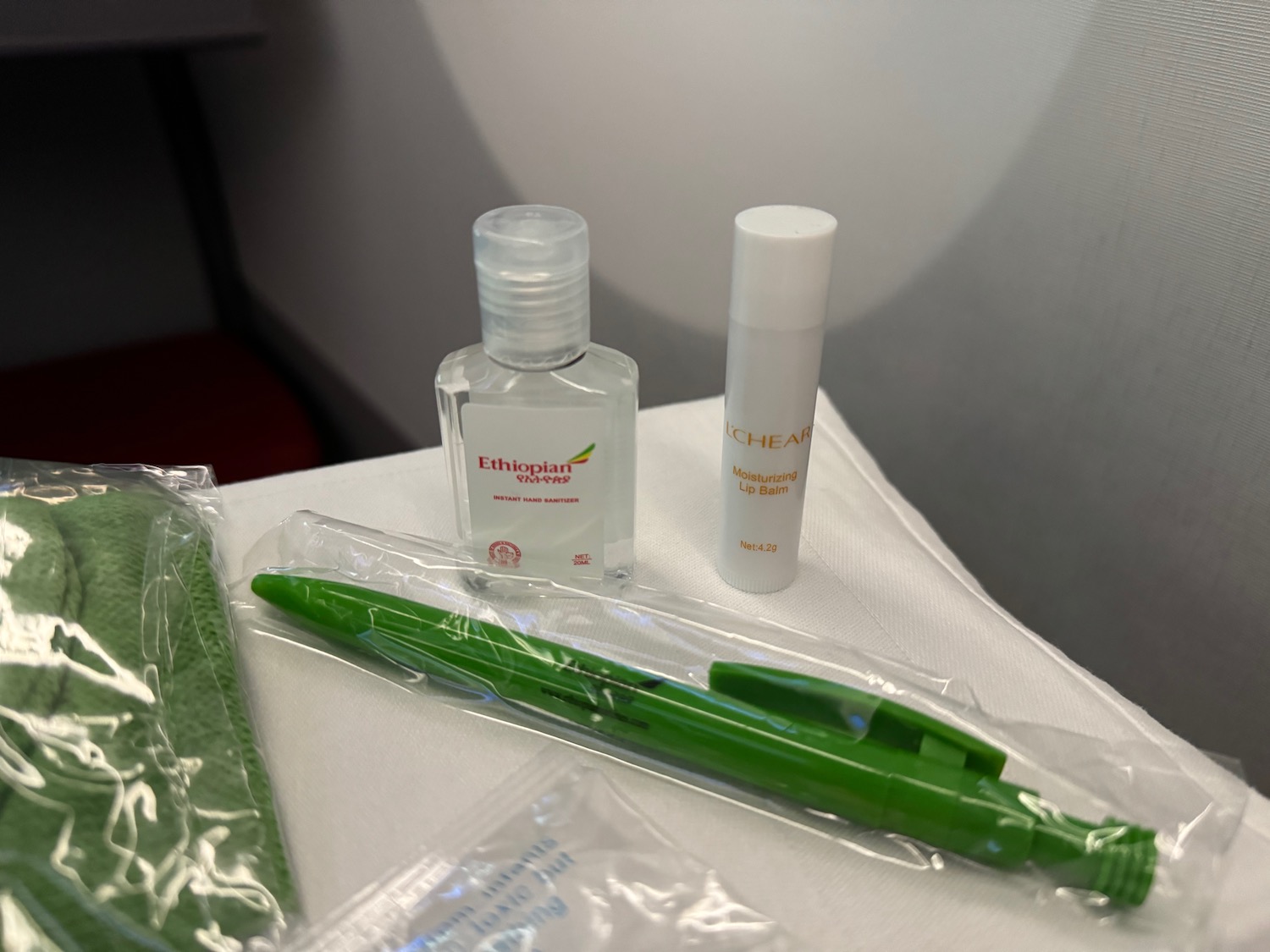 a green pen and a bottle of hand sanitizer