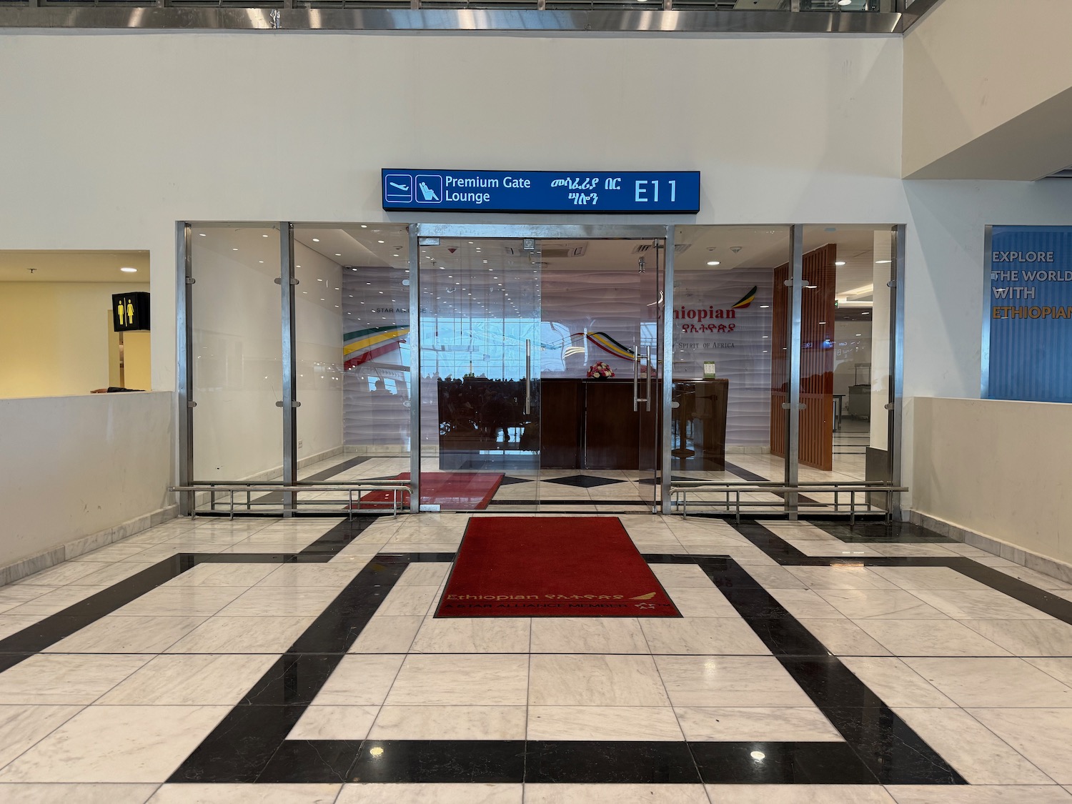 a glass door with a red rug in front of it