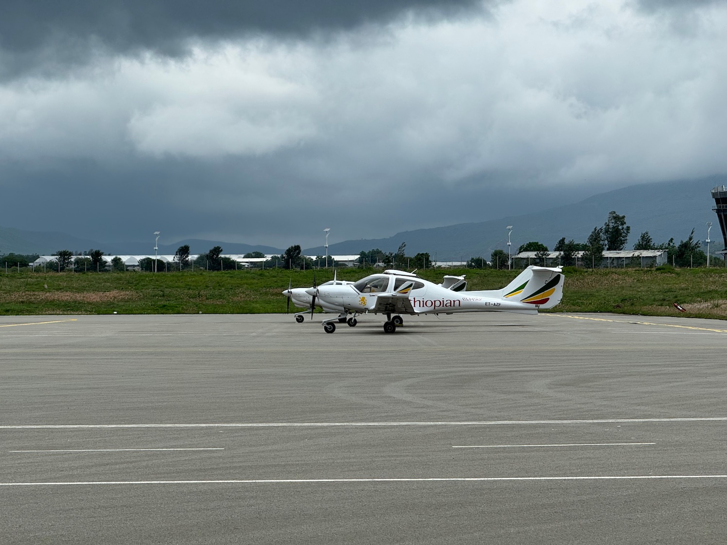 a small white airplane on a runway
