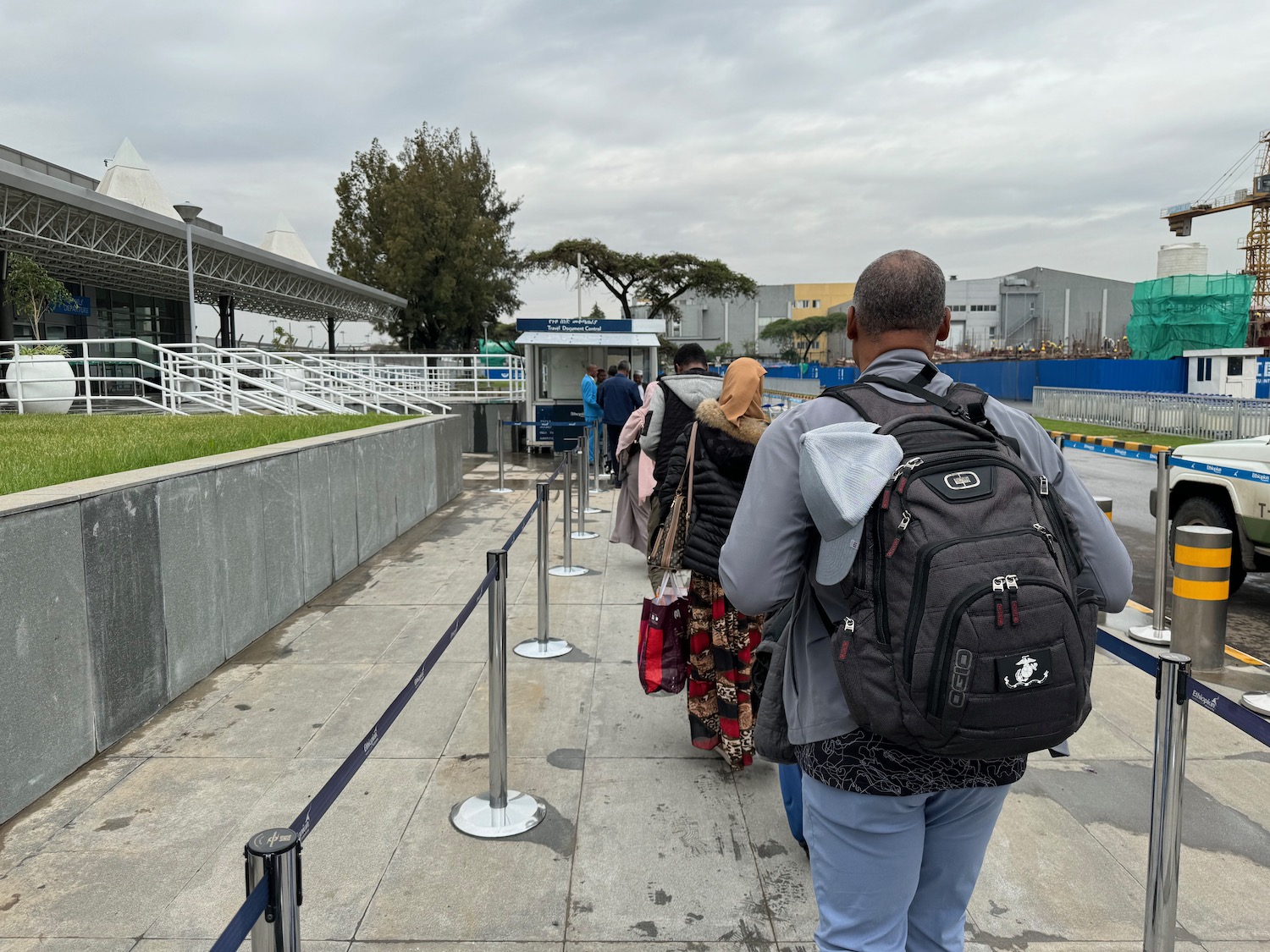 a group of people walking on a sidewalk