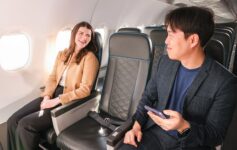 a man and woman sitting in an airplane