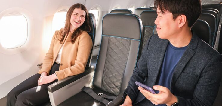 a man and woman sitting in an airplane