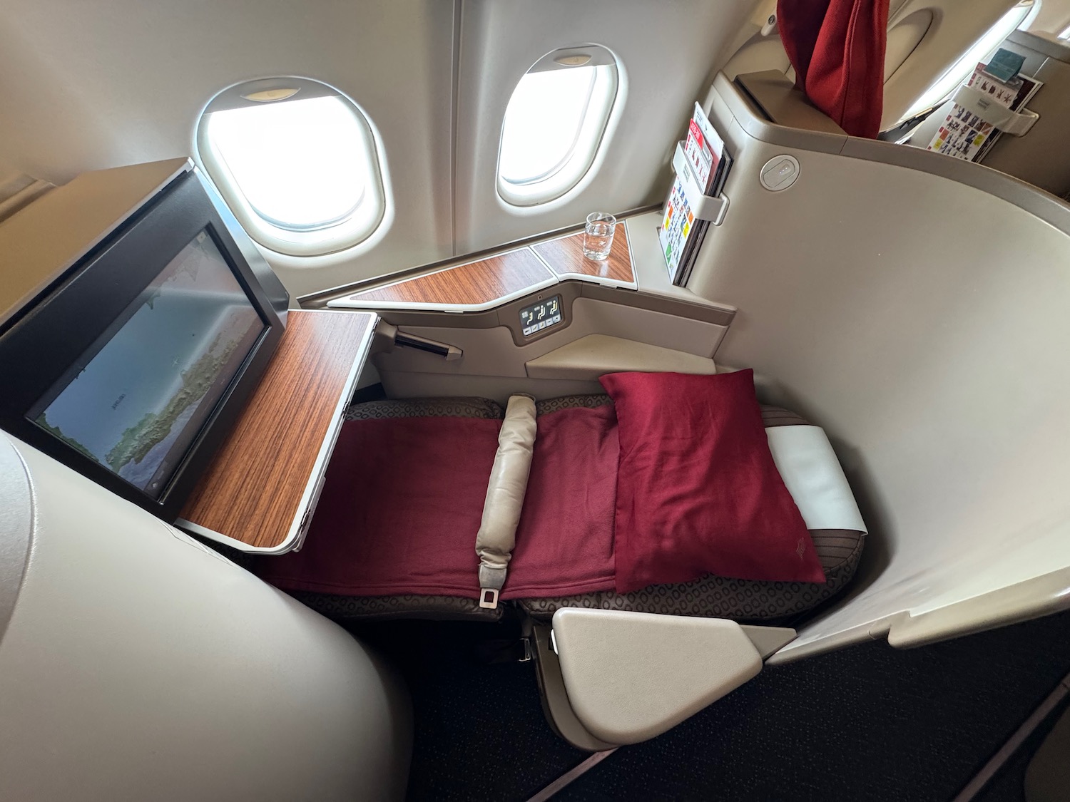 a seat with a red pillow and a red pillow on the side of the seat