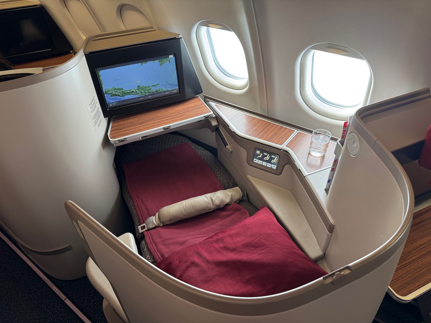 a bed with a tv in the back of an airplane