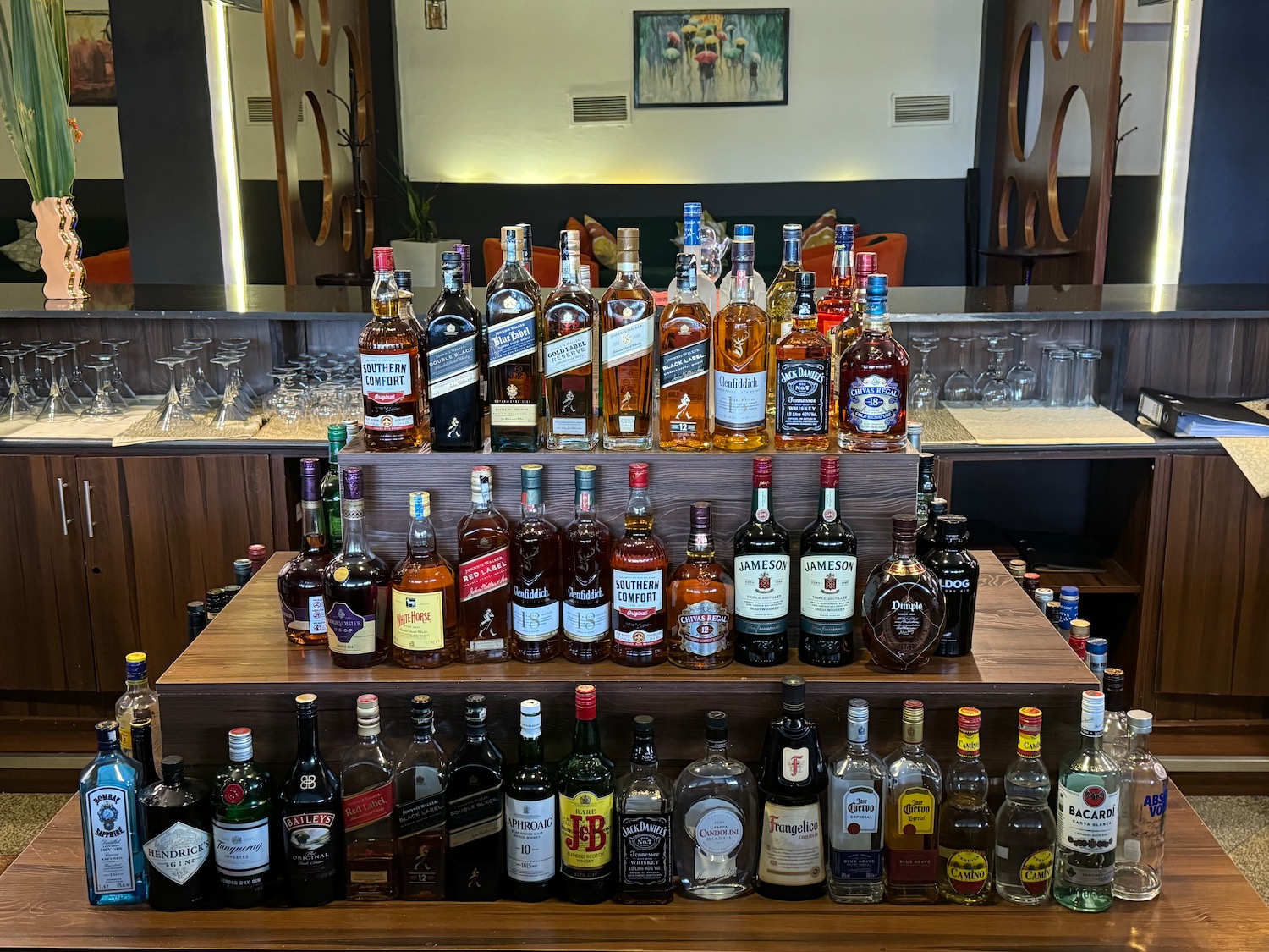 a group of bottles of alcohol on a shelf