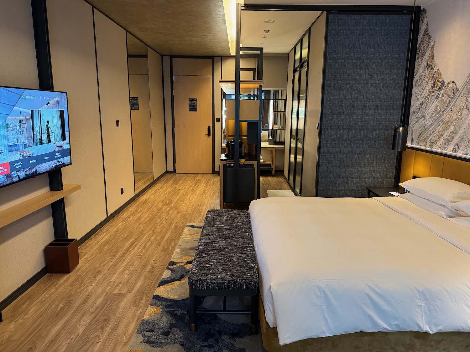 a bedroom with a bed and a television