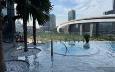 a pool with a large building in the background