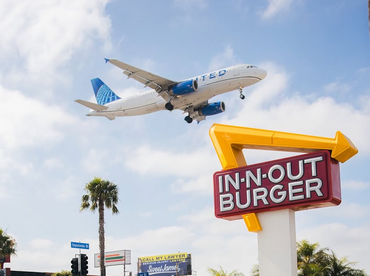 a plane flying over a sign