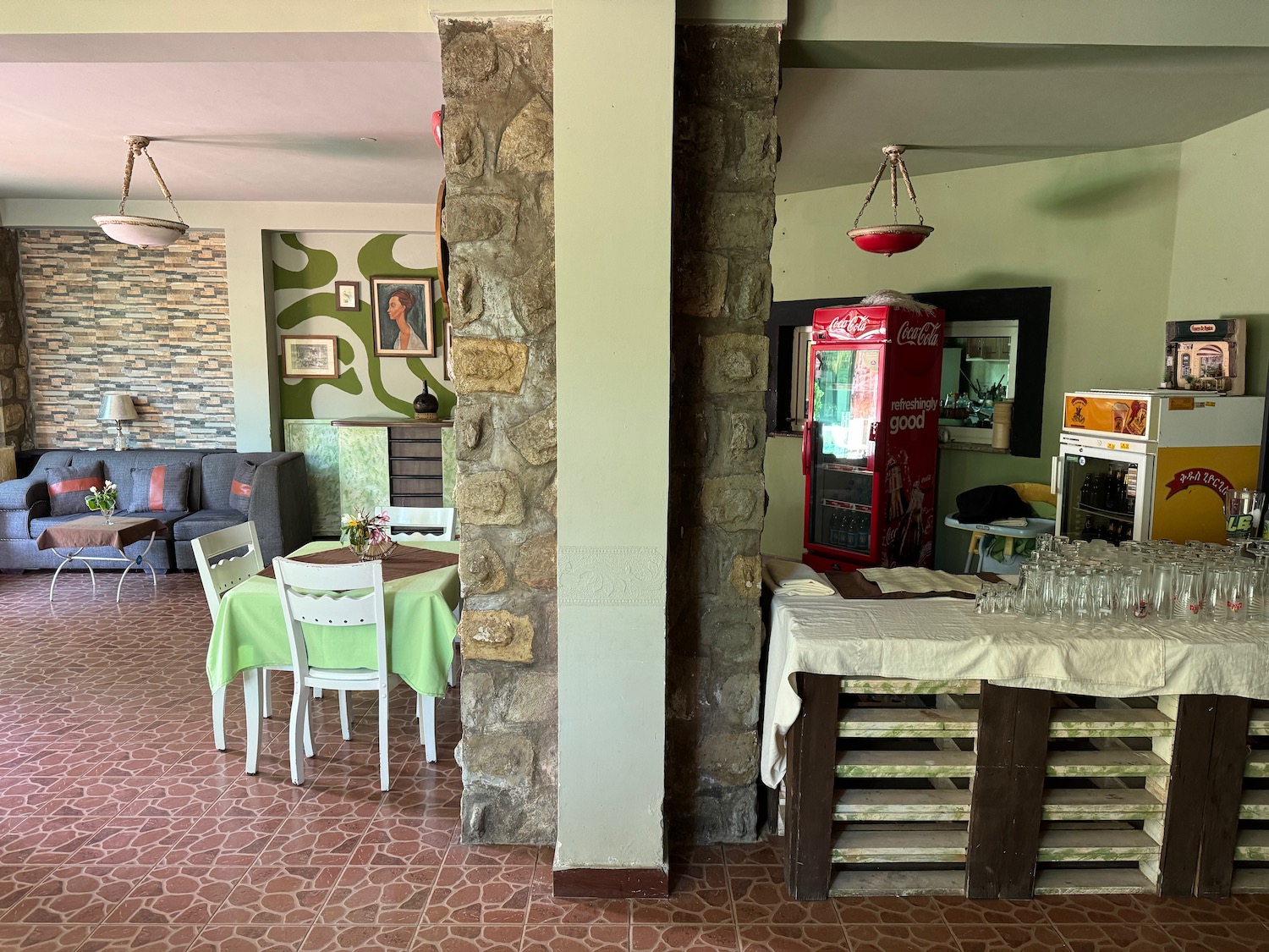 a room with a stone wall and a table and chairs