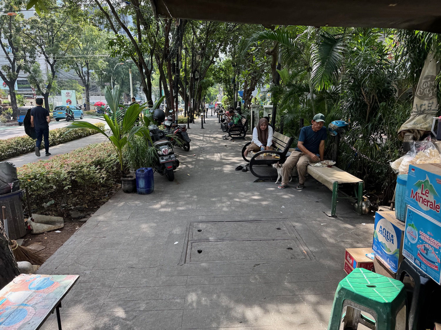 a man and woman sitting on benches under a canopy