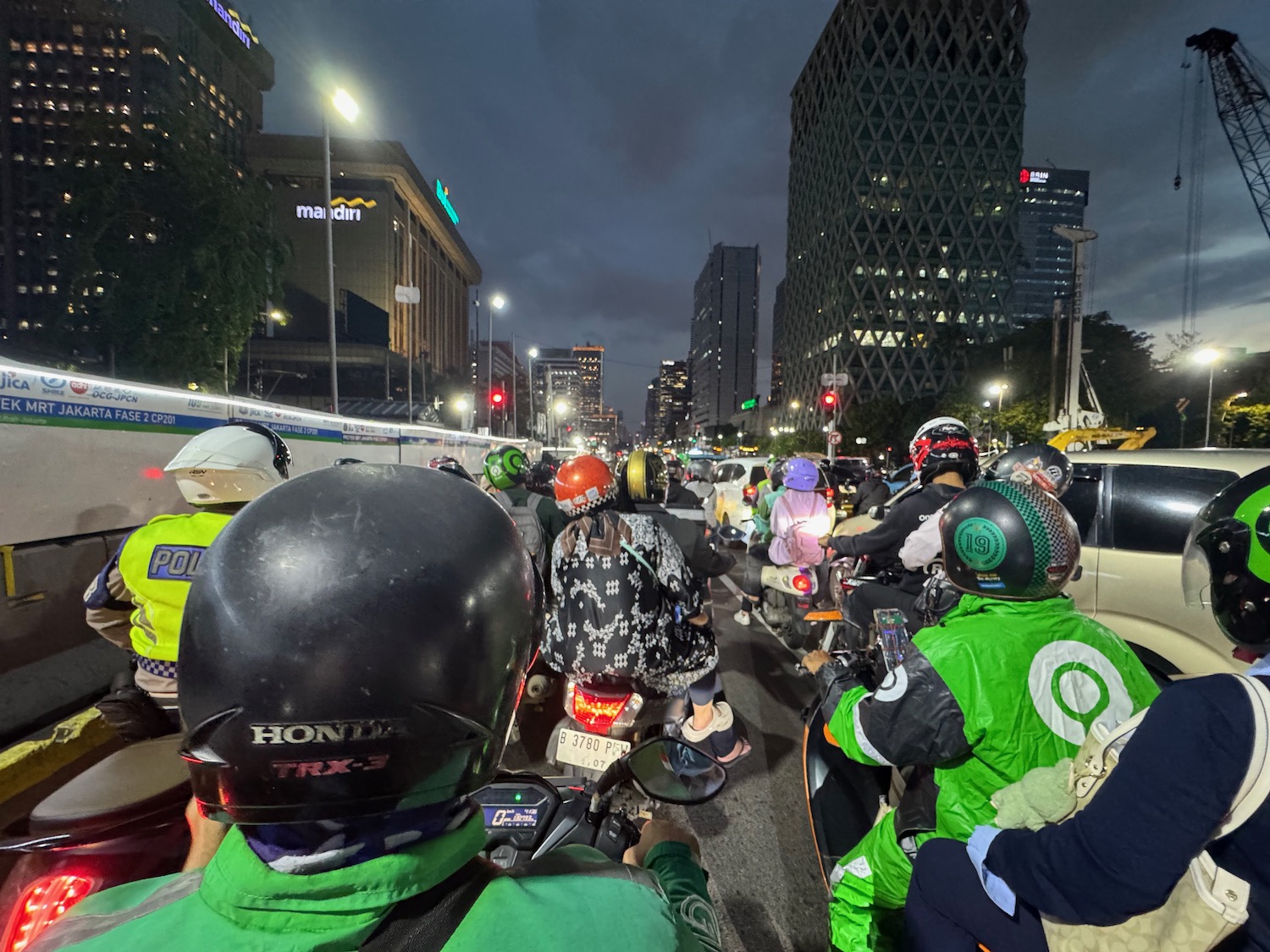 a group of people on scooters in a city street