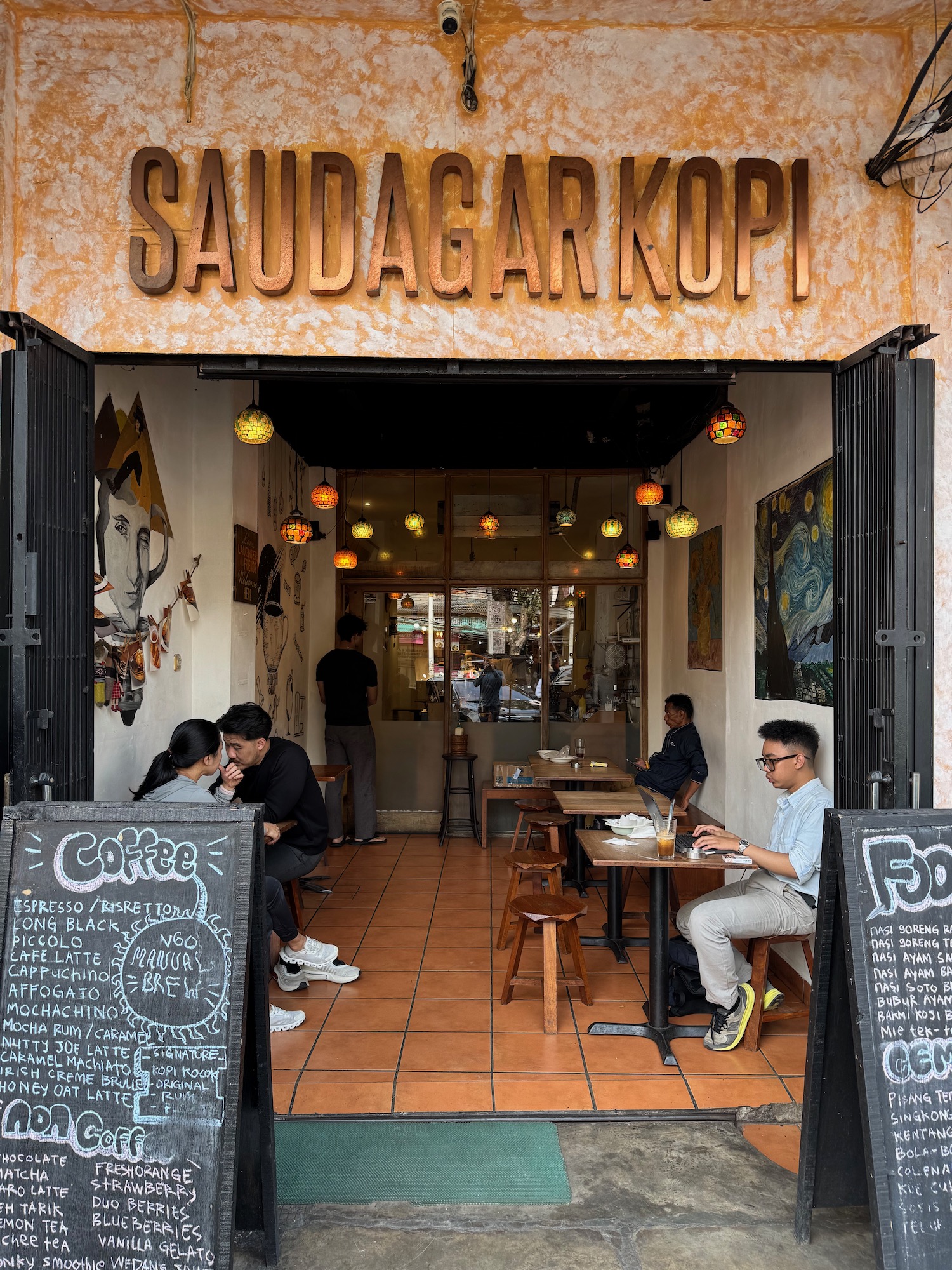 a group of people sitting at tables outside a restaurant