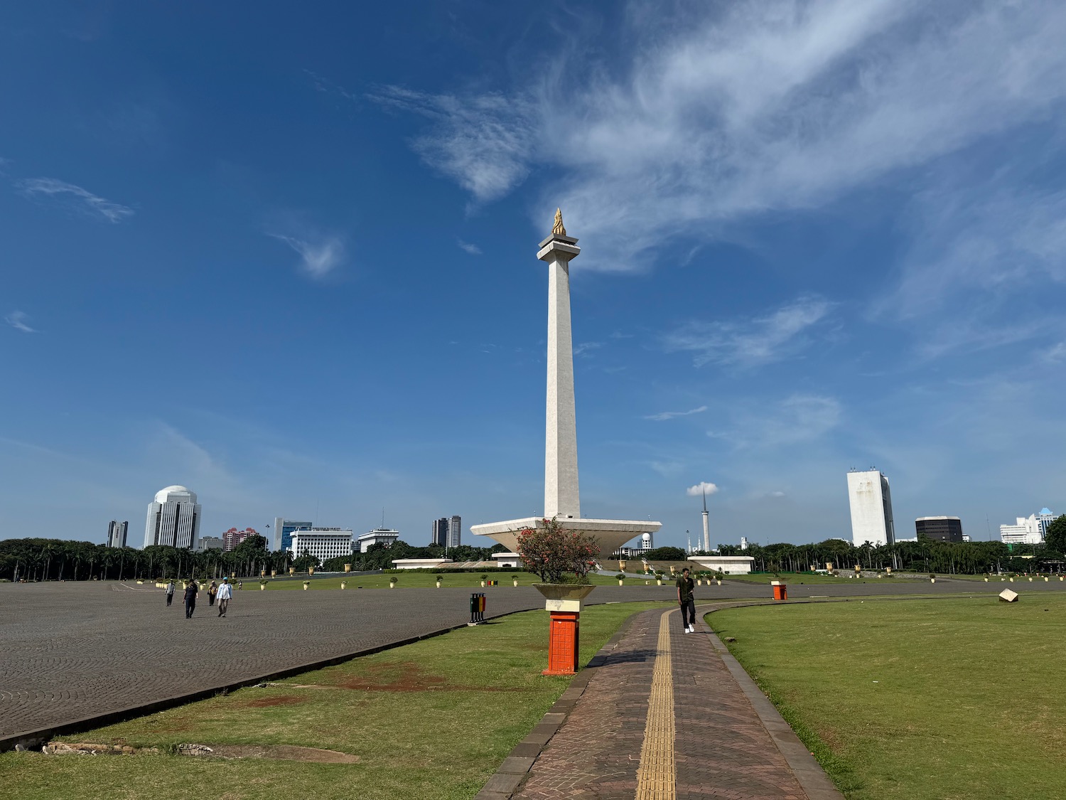 a tall white tower in a park