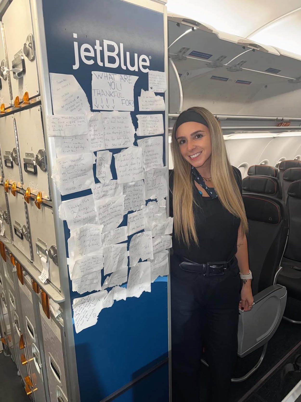 a woman standing next to a sign with notes on it
