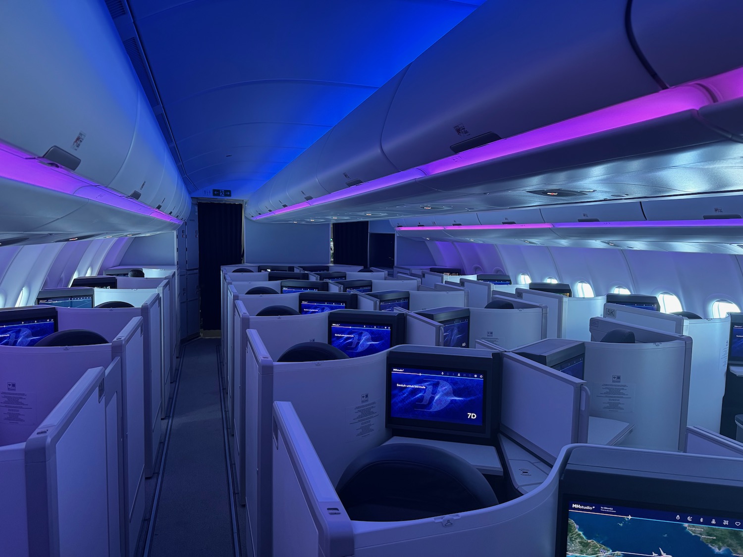 a row of seats with monitors on the side