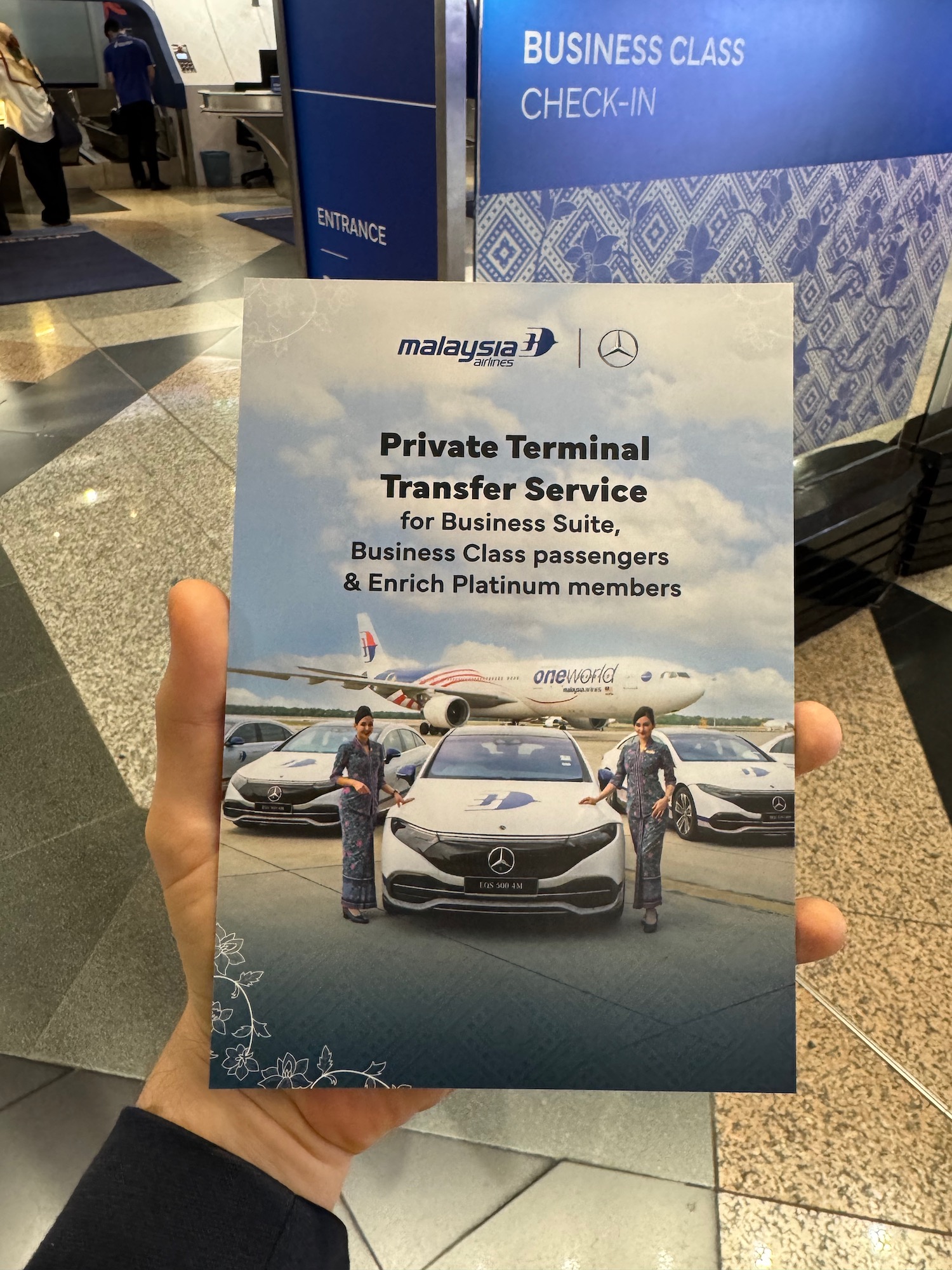 a hand holding a brochure