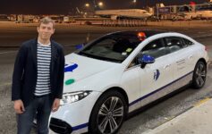 a man standing next to a car