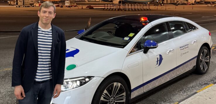 a man standing next to a car