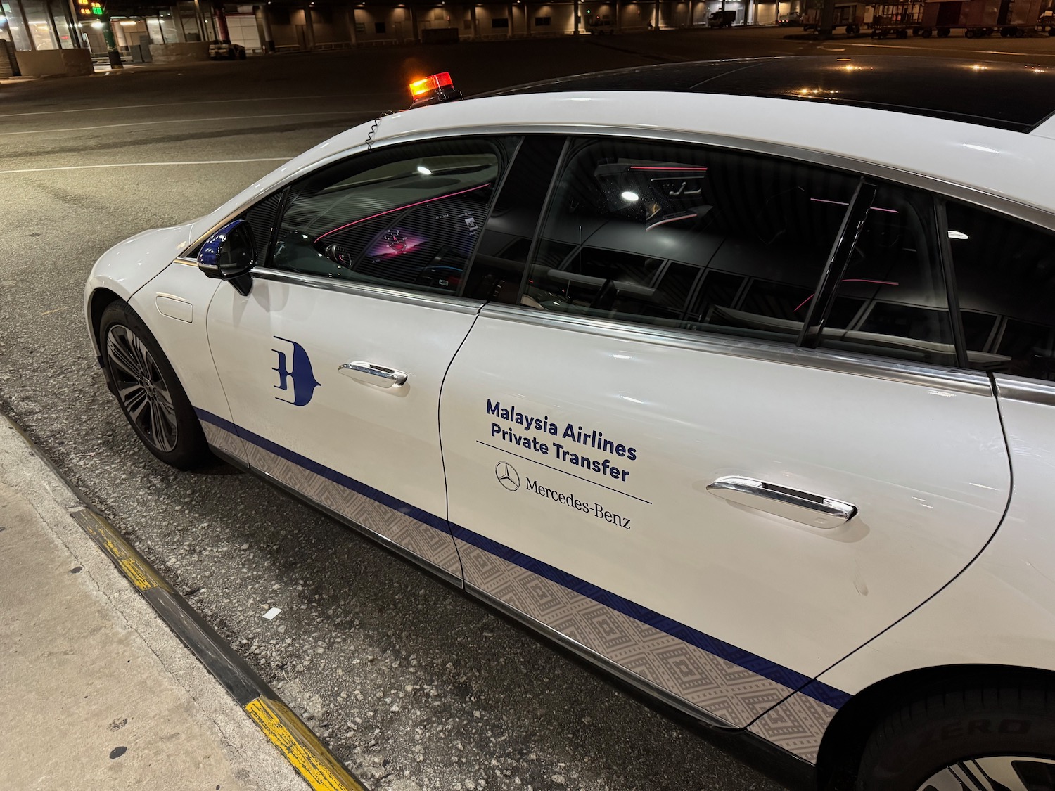 a white car parked on the side of a road
