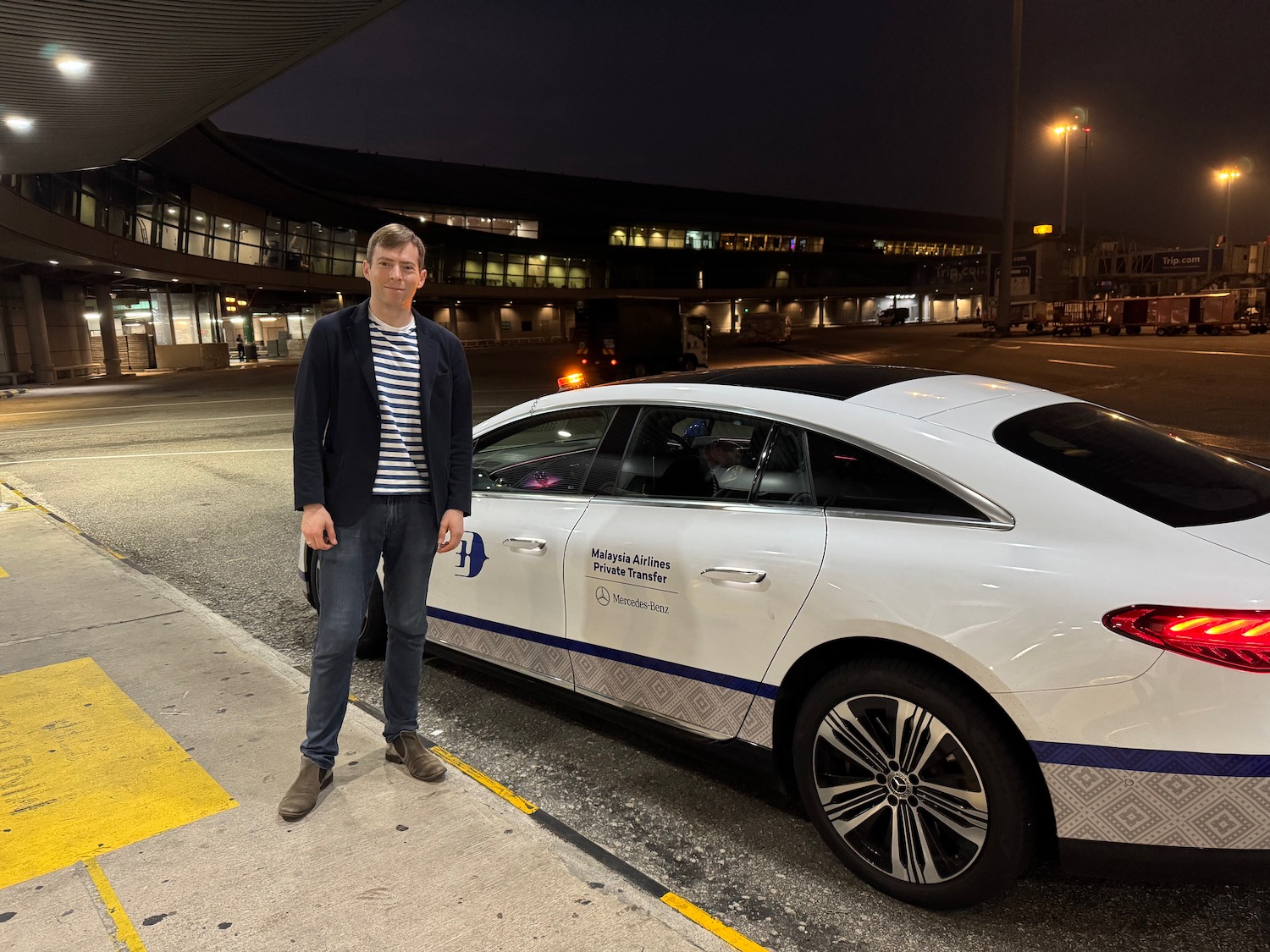 a man standing next to a car