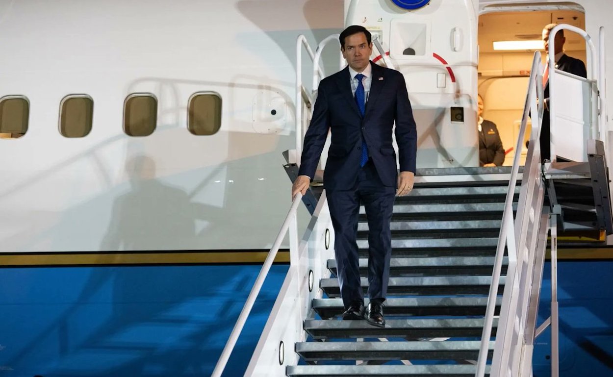 a man in a suit walking up stairs