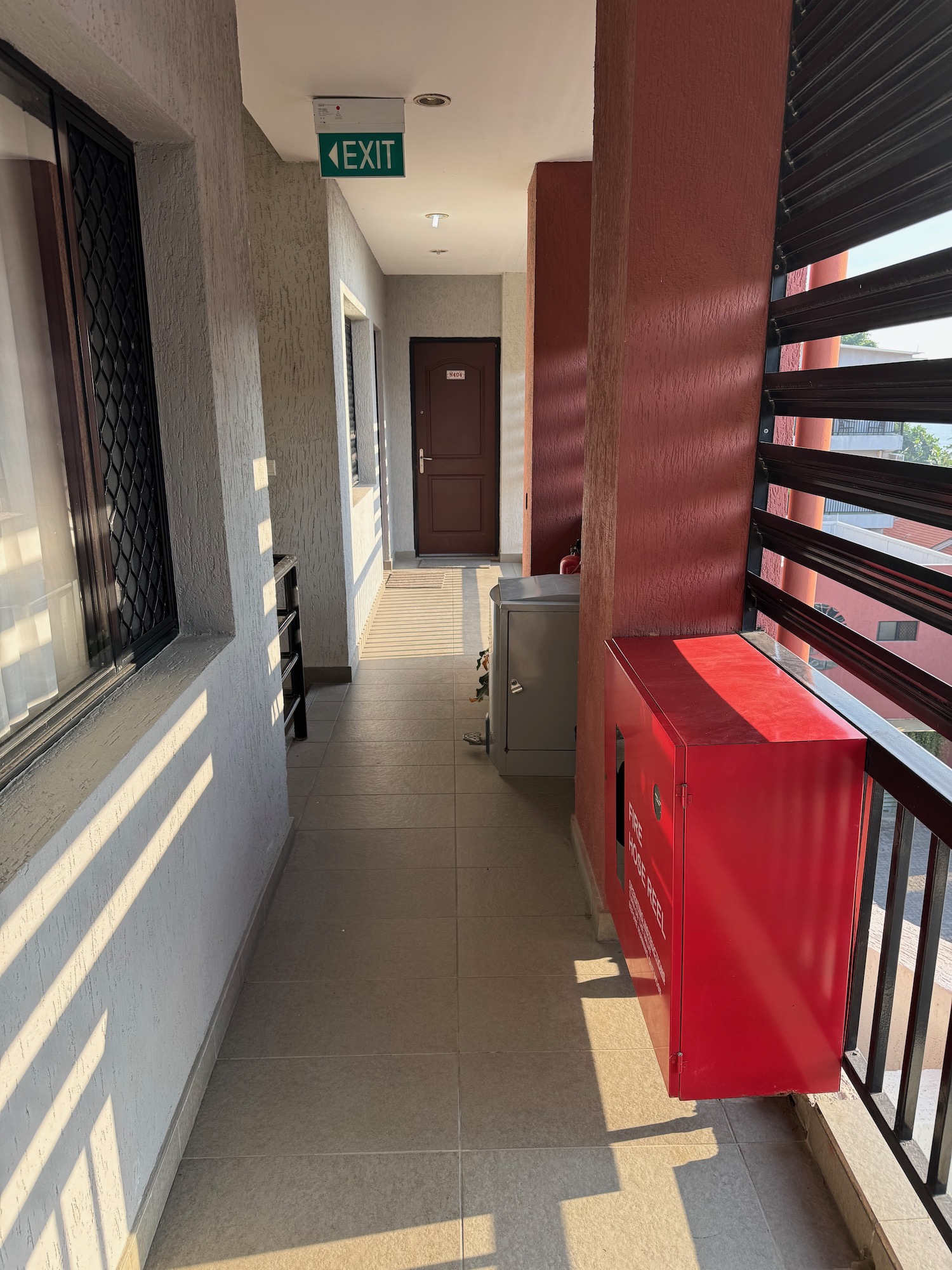 a hallway with a red box and a door