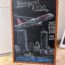 a chalkboard with a drawing of an airplane and cityscape