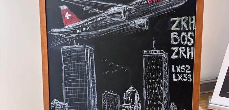 a chalkboard with a drawing of an airplane and cityscape
