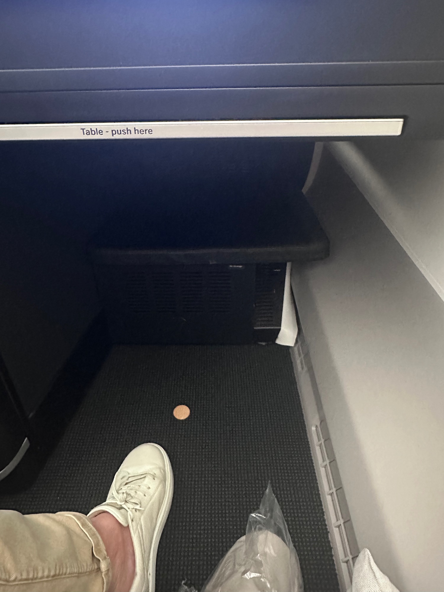 a person's feet in a small room with a coin