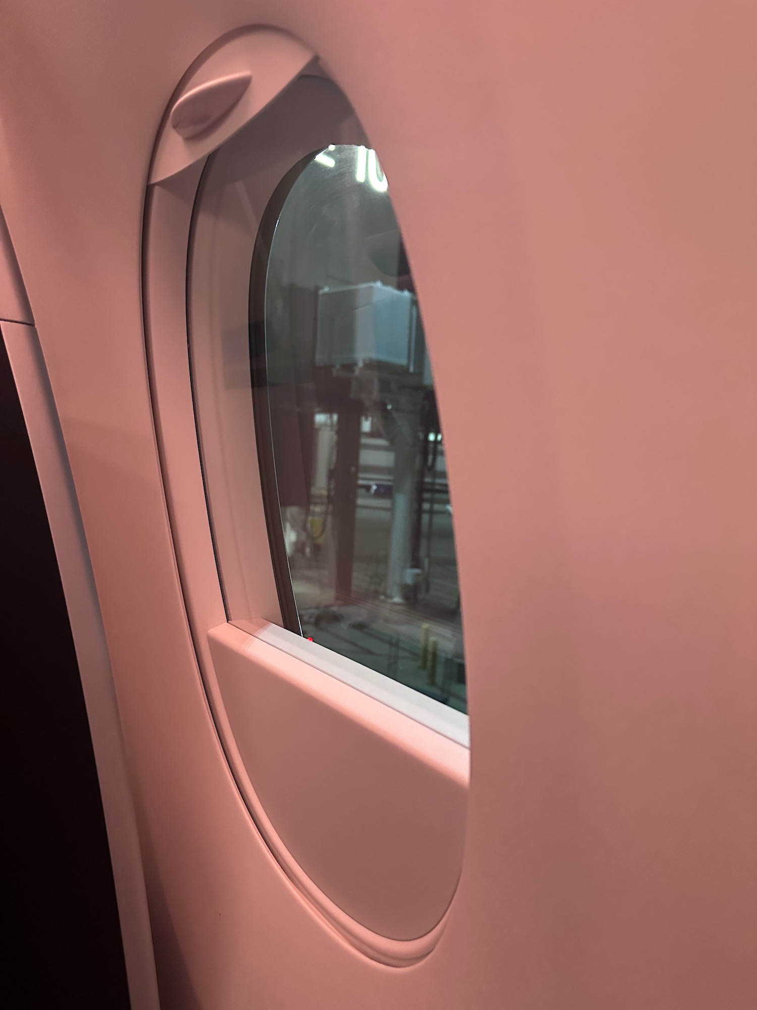 a window on a pink wall