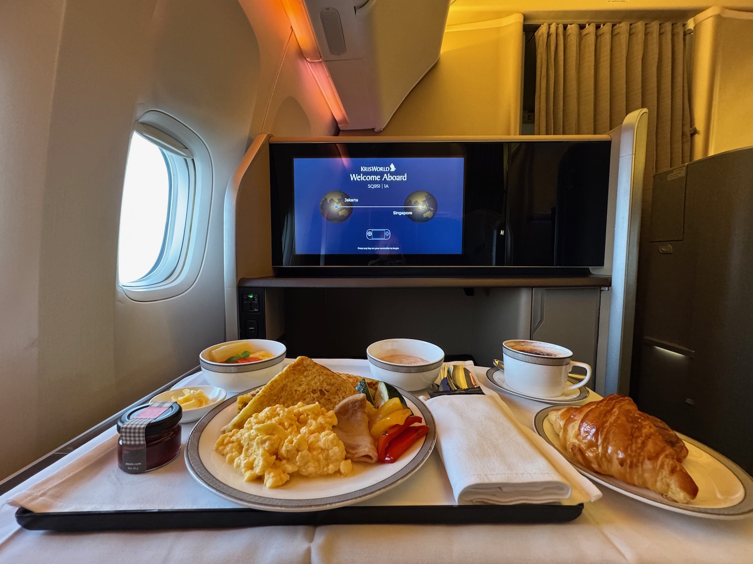 a tray of food on a table in an airplane