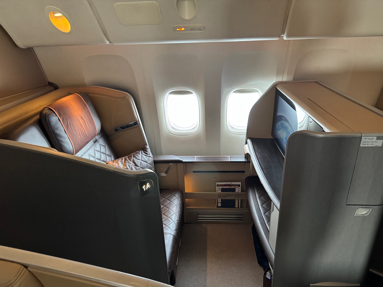 a seat and a television in an airplane