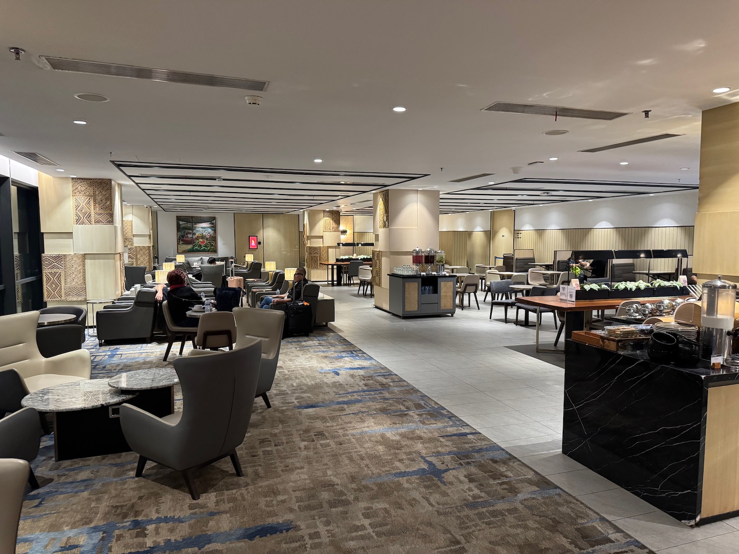 a room with a large area with tables and chairs