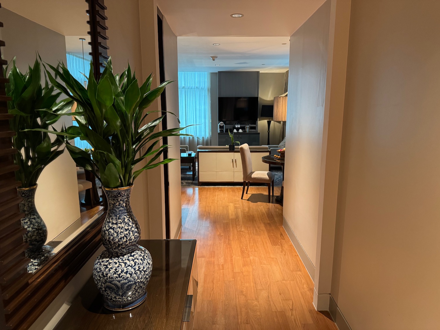 a hallway with a plant in a vase