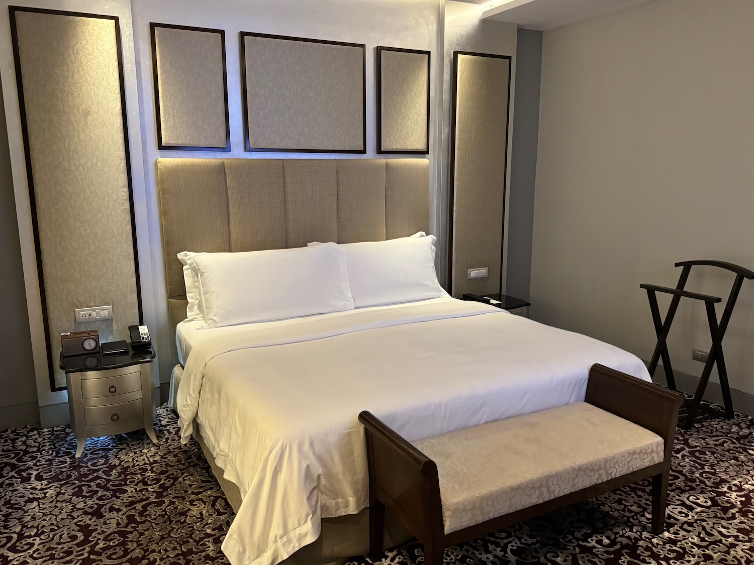 a bed with a headboard and a chair in a room