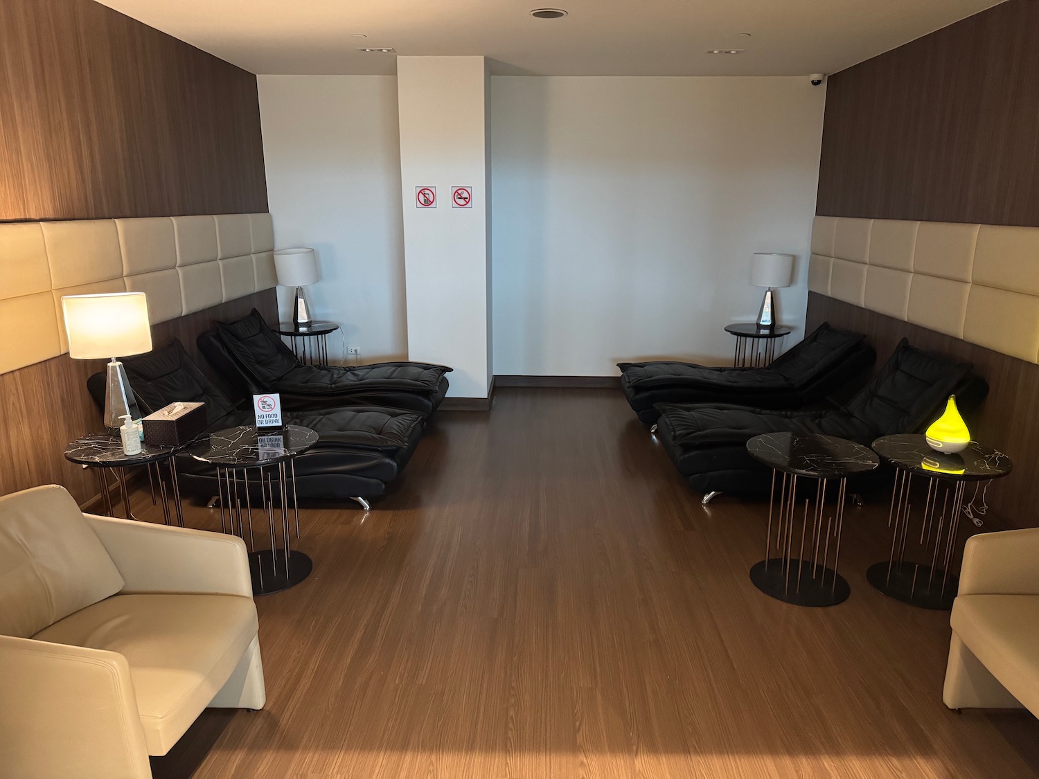 a room with black chairs and a wood floor