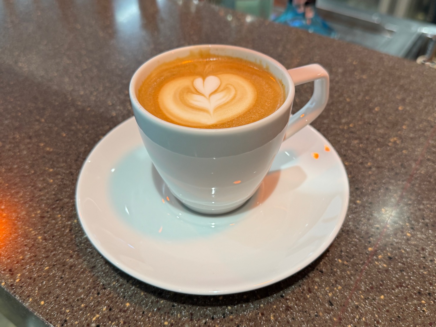 a cup of coffee with a heart shaped foam in it