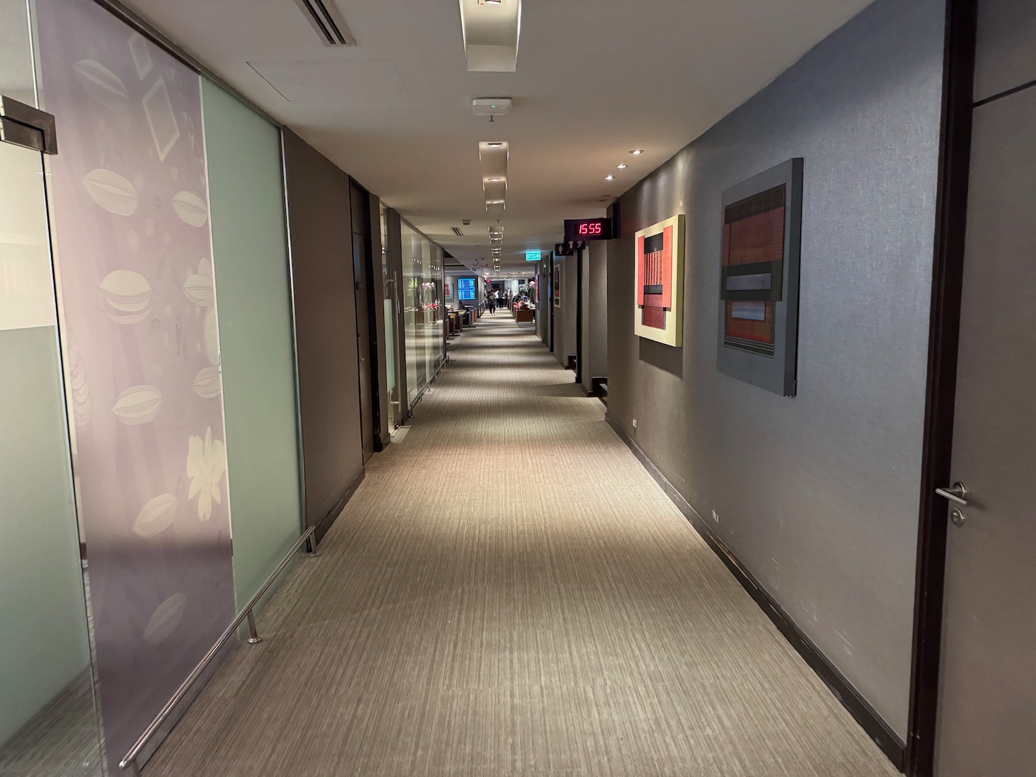 a hallway with many doors and a sign