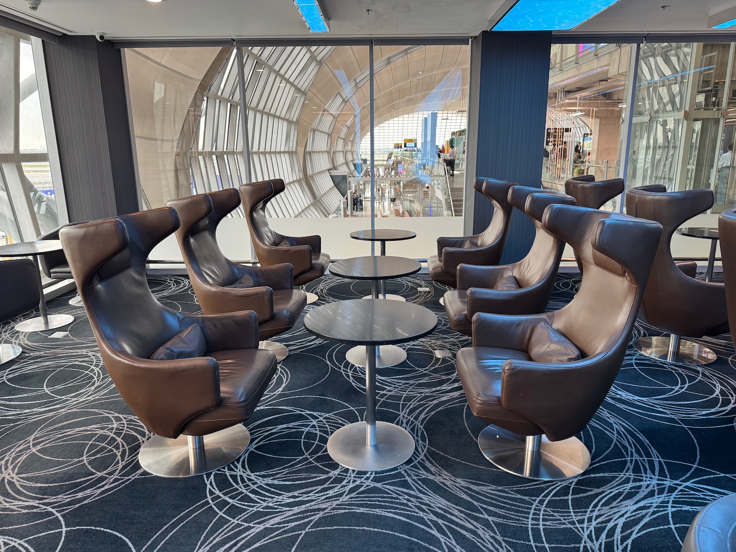 a group of brown chairs and a table in a room
