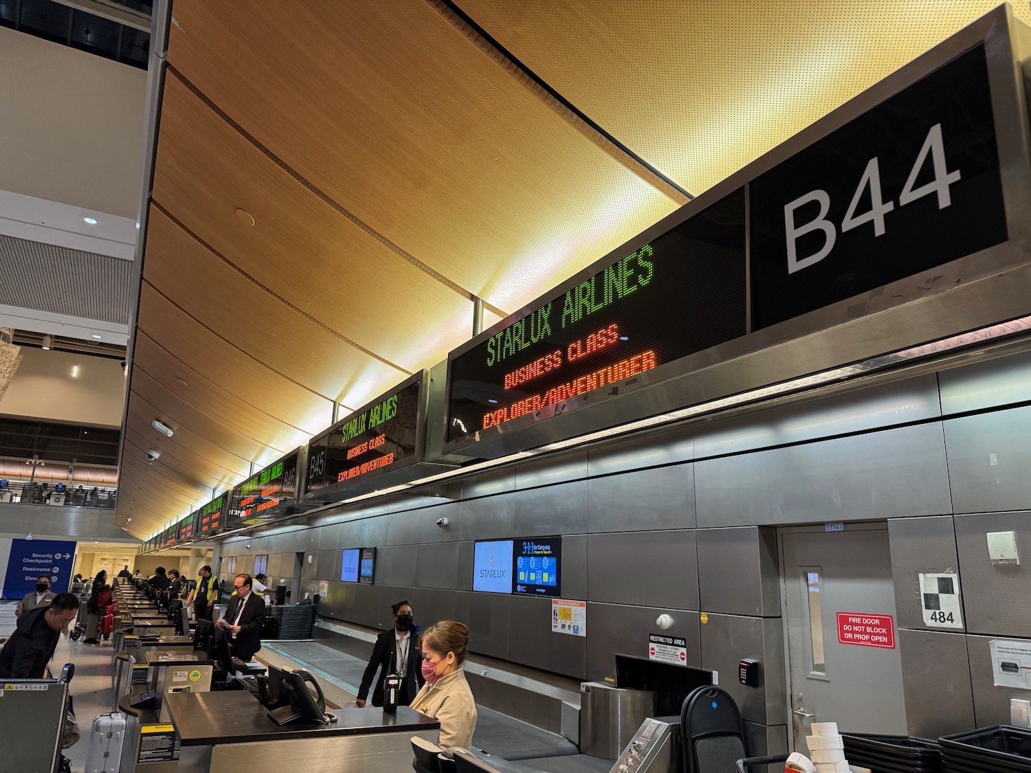 people at an airport check in counter