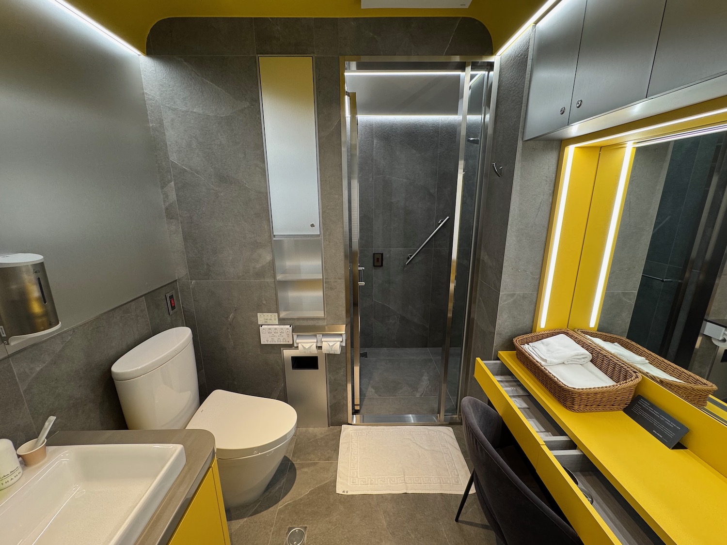 a bathroom with yellow walls and a sink