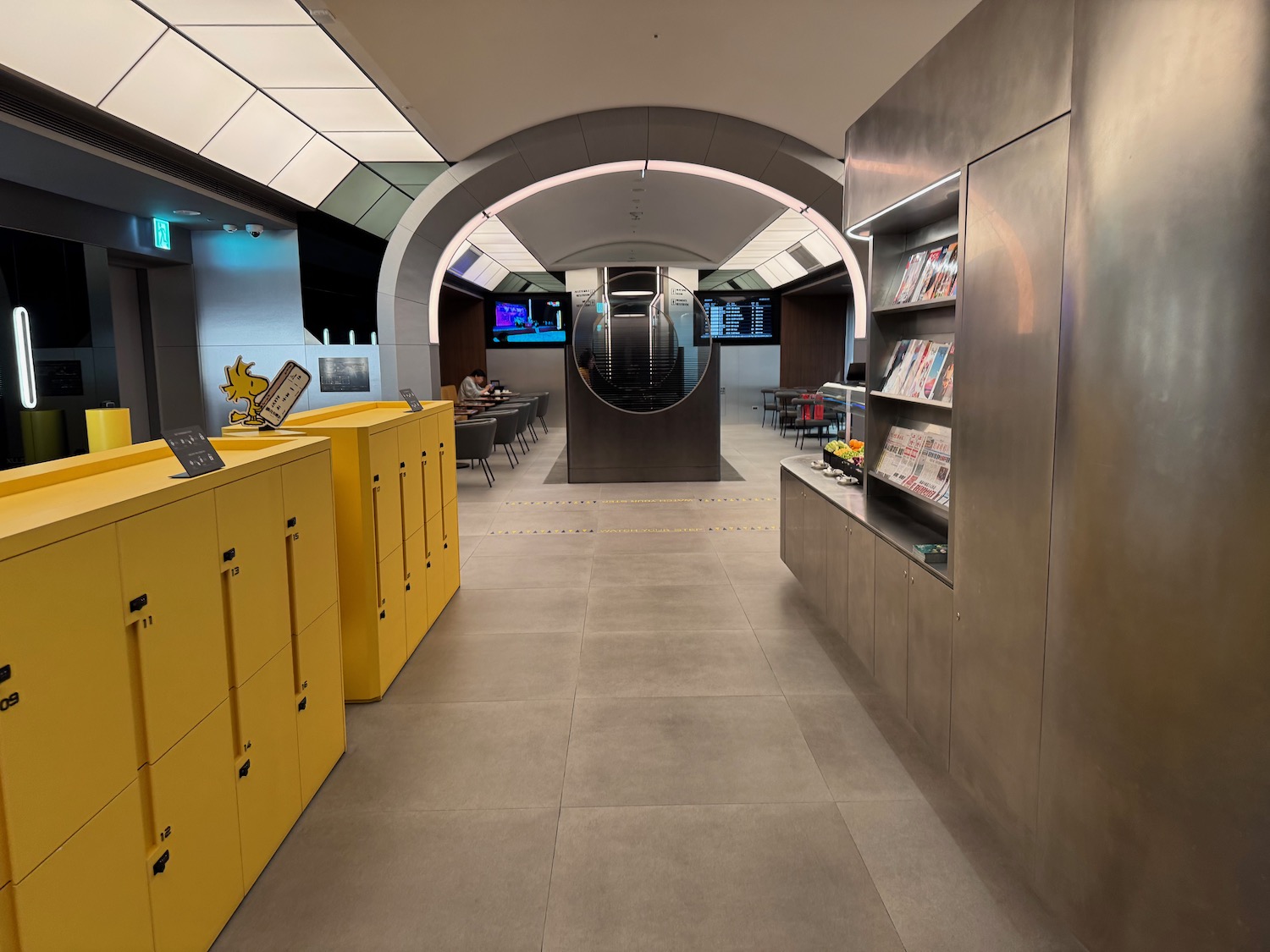 a room with yellow cabinets and bookshelves
