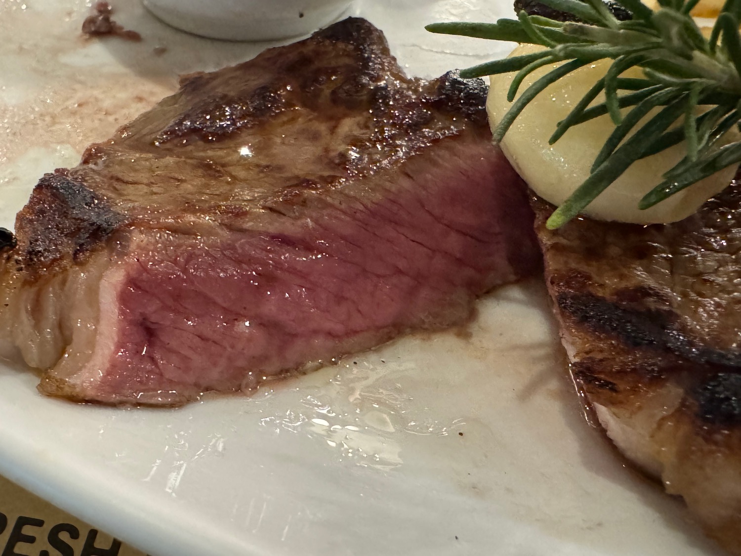 a plate of steak and rosemary