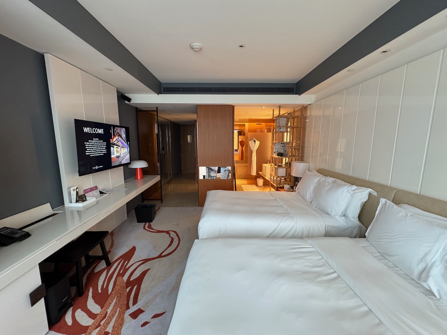 a room with two beds and a tv